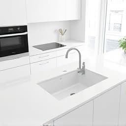 White solid surface countertop installation in modern kitchen